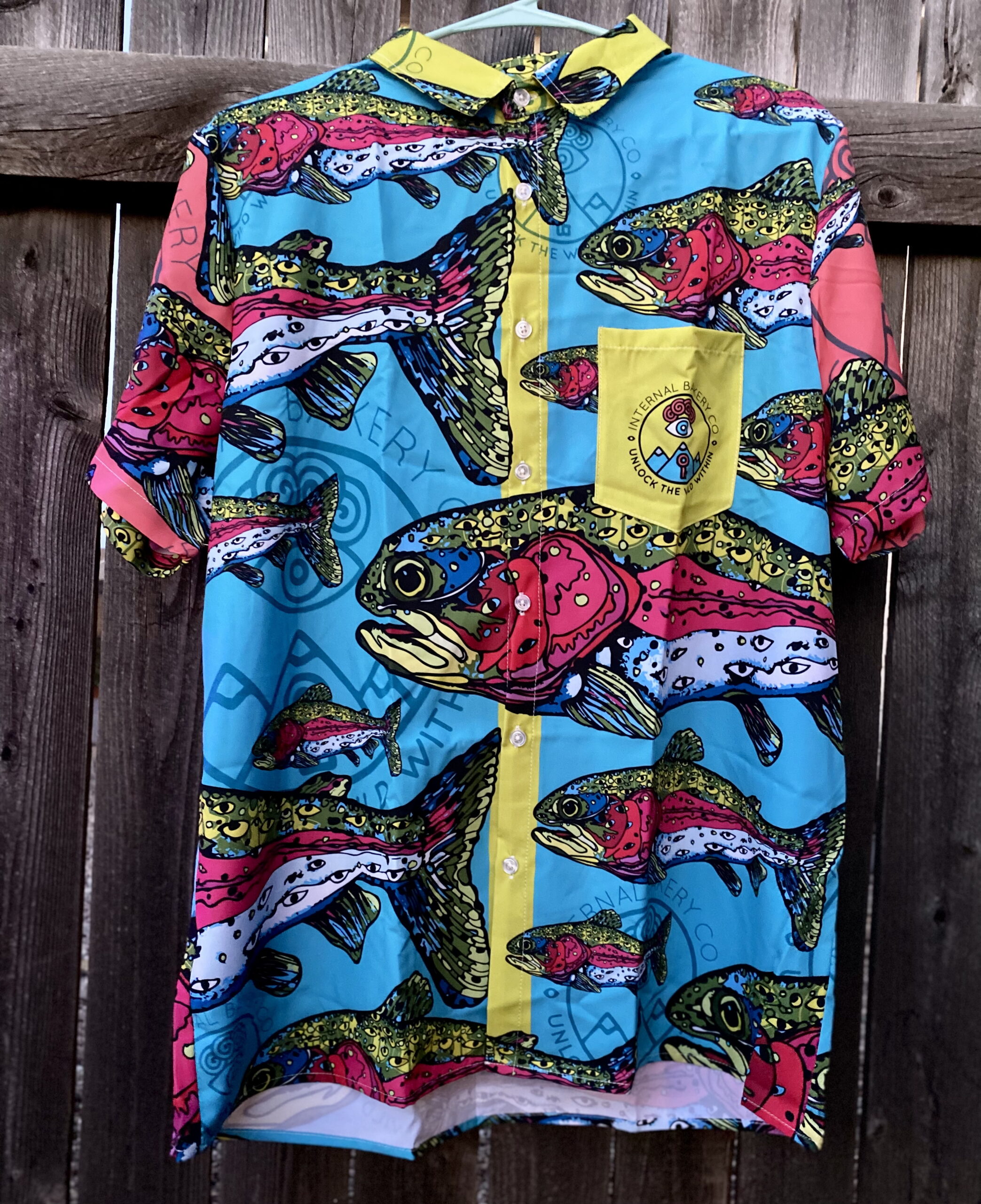 The 'Lookout Trout' Friend-Making Shirt – See the Wild 🎨🐟👁️ Dive into a world of imagination with the Lookout Trout Button-Up, featuring Zach Ray’s hand-drawn Rainbow Trout where speckles become watchful eyes. A fusion of vibrant color and surreal design, this shirt captures the spirit of adventure—perfect for those who love to stand out and spark conversations. More than just a shirt, it’s a statement piece that invites curiosity, connection, and creativity. Whether you're by the water, in the mountains, or out in the wild, the Lookout Trout is your bold companion for any adventure. ✨ Wear the unexpected. Make new friends. Unlock the Wild Within.