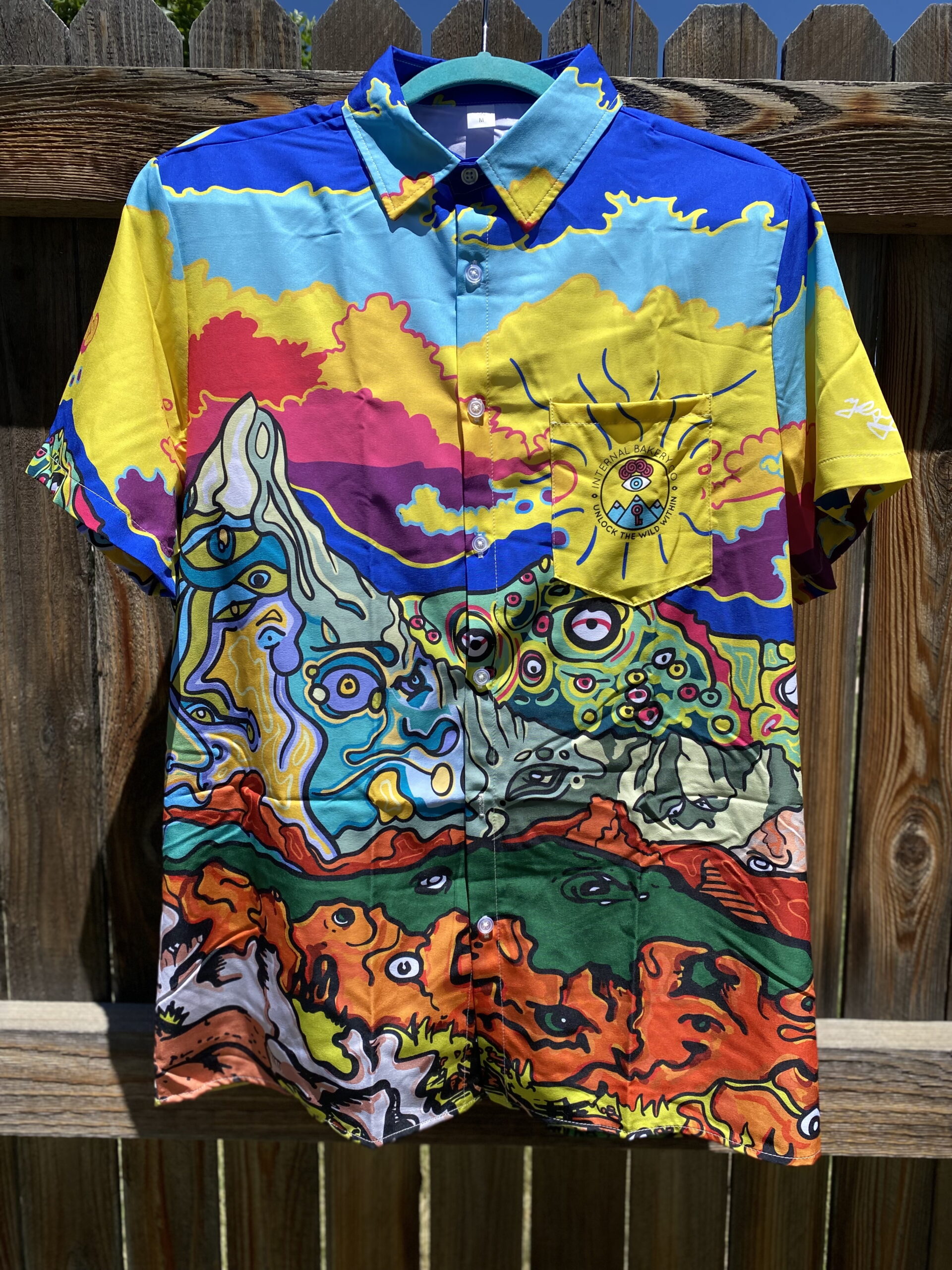 The 'Trippy Mountain' Friend-Making Shirt – See the Wild 🎨🐟👁️ Dive into a world of imagination with the Trippy Mountain Button-Up, featuring Zach Ray’s hand-drawn Front Range Mountains and Garden of the Gods with faces and characters embedding into the scene, this shirt captures the spirit of adventure—perfect for those who love to stand out and spark conversations. More than just a shirt, it’s a statement piece that invites curiosity, connection, and creativity. Whether you're by the water, in the mountains, or out in the wild, the Trippy Mountains is your bold companion for any adventure. ✨ Wear the unexpected. Make new friends. Unlock the Wild Within.