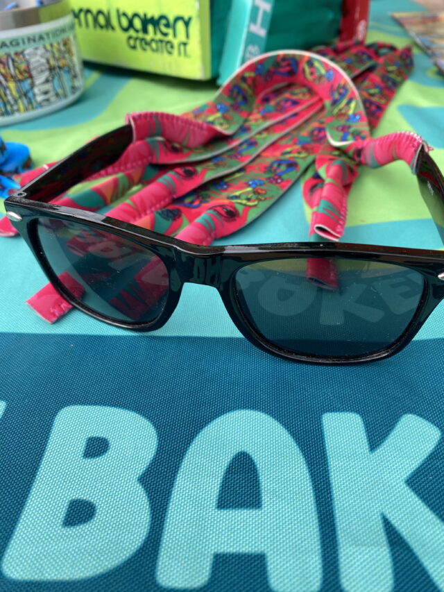 Croakies – Mushroom Sunglasses Strap Because nothing kills the vibe faster than watching your sunglasses slip into the water mid-cast. These Croakies keep your shades locked in, whether you’re reeling in a rainbow trout, hiking Garden of the Gods, or dancing at a summer festival. Printed across the strap is my original hand-drawn mushroom cluster—happy little shrooms in vibrant, tropical-inspired colors that bring a playful edge to your outdoor gear. Functional, durable, and full of personality, they’re made for adventurers who see the world a little differently. – Original hand-drawn mushroom design – Tropical, full-color print with mushy vibes – Durable + comfortable strap that fits most sunglasses – Perfect for fishing, hiking, festivals + everyday adventure – Designed in Colorado Springs, CO Because even your sunglasses deserve a little wild imagination.
