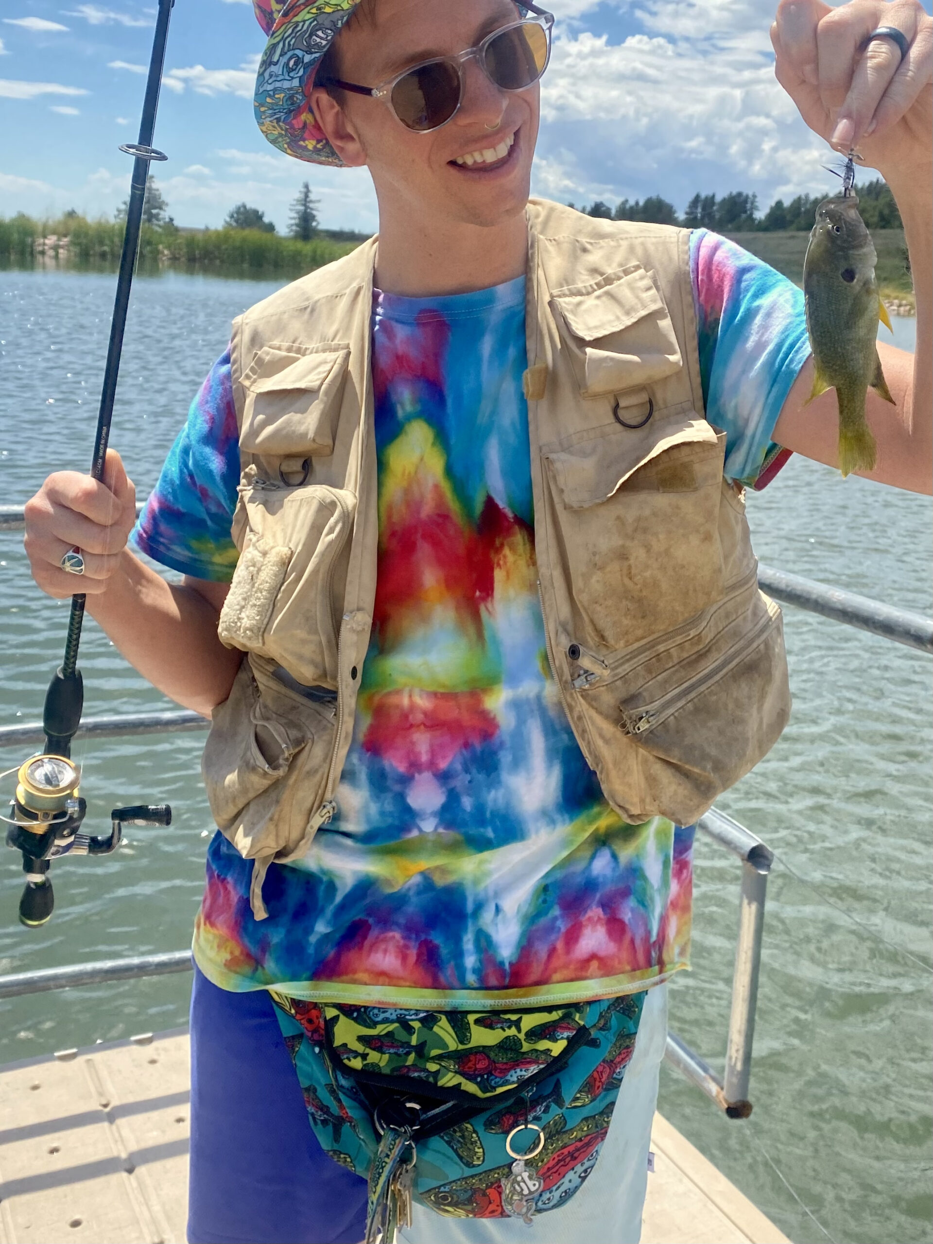 Lookout Trout Fanny Pack — Hand-Drawn by Internal Bakery 🎨🐟 Meet the Lookout Trout Fanny Pack — a colorful, hand-drawn design brought to life by Internal Bakery. Inspired by the rainbow trout and reimagined through an imaginative lens, each speckle has been transformed into watchful eyes, turning this fish into a living piece of art that’s guaranteed to catch attention wherever you go. This pack features a multi-colored panel layout and two roomy zip pockets — one large in the front and a hidden pocket on the back — giving you space for all your essentials while keeping your hands free. Whether you’re fishing, hiking, traveling, working, or just on the move, this pack blends bold creativity with everyday functionality. Customers can’t stop raving about the quality, comfort, and conversation-starting design — it’s the perfect balance of utility and imagination. Perfect for: 🌈 Everyday use & travel 🎣 Fishing & outdoor adventures 🎨 Festivals & creative outings 🧤 On-the-job or hands-free days Empty your pockets, strap in, and let your imagination go wild.