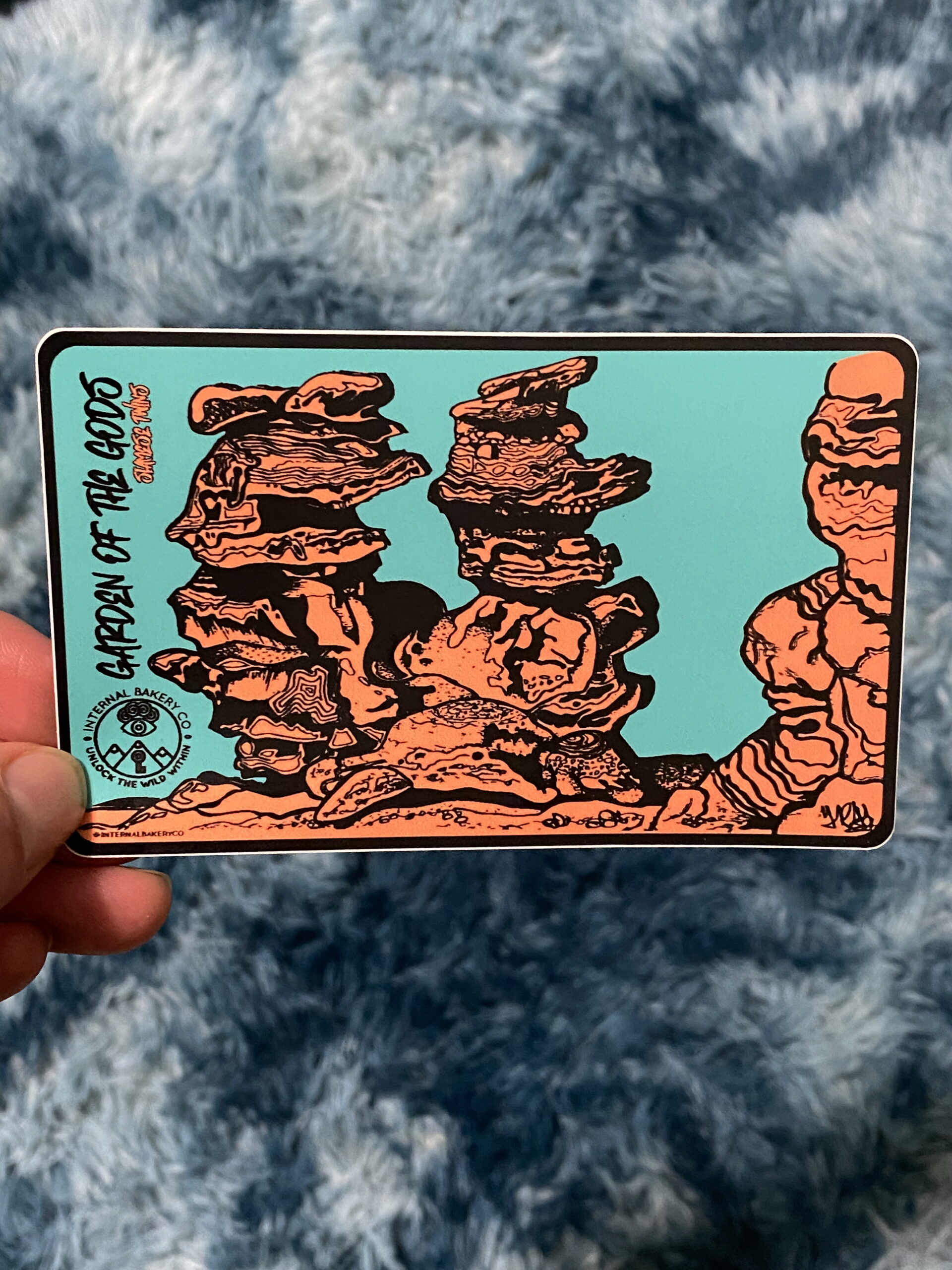 Siamese Twins” Sticker (5″ × 3″) This hand-drawn pen and ink piece captures the iconic Siamese Twins rock formation at Garden of the Gods — a view every local knows, but few have seen like this. Drawn in my signature style, the lines flow naturally, and if you look close enough, you might spot faces or shapes coming to life on their own. That’s the beauty of imagination — it’s not about what you put in, but what you discover once it’s there. Finished with the new Internal Bakery logo, this design pays homage to Colorado Springs and the creative flow that starts right here.