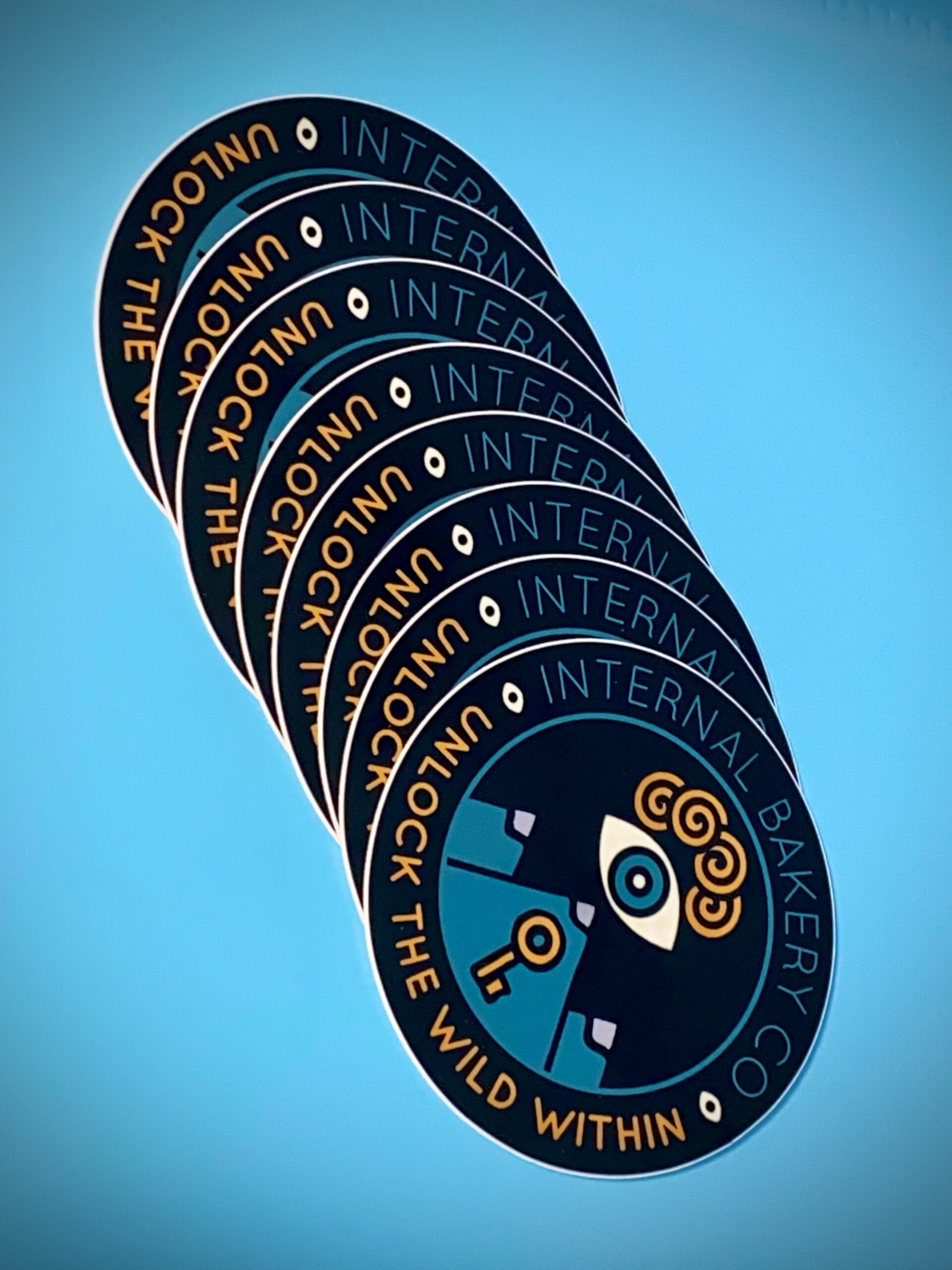 Internal Bakery Logo Sticker (3”) Unlock the Wild Within. This 3-inch sticker features the reimagined Internal Bakery logo — a symbol of imagination, curiosity, and the wild creative spirit that lives inside us all. Hand-drawn and designed in Colorado Springs, this mark represents the heart of our rebrand: Unlock the Wild Within. Stick it anywhere that needs a little spark — your water bottle, laptop, sketchbook, or car window — and let it remind you to keep creating, keep exploring, and keep seeing the world through your own wild lens. Durable, weatherproof, and made to last — just like your imagination.