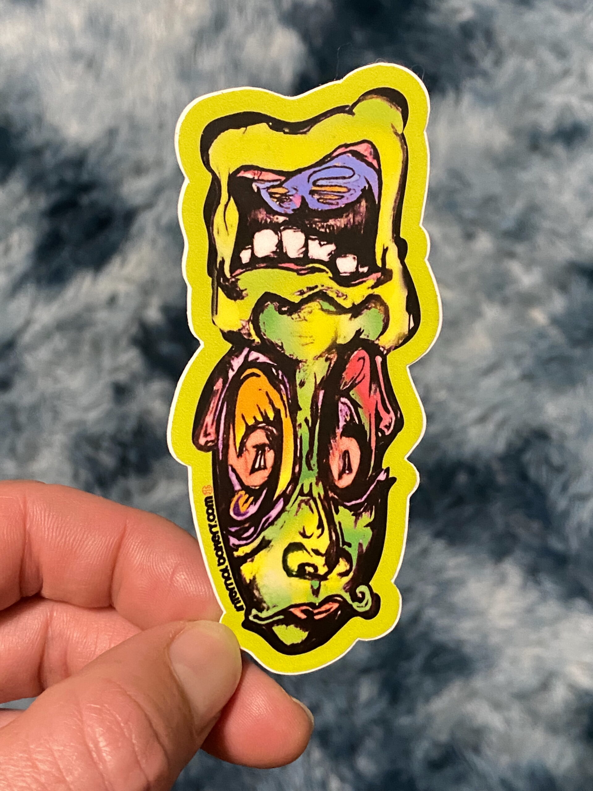 JOHNNY 2FACE STICKER — 3" (The OG) Meet Johnny 2Face — the original mind-twister that started it all. One way, he’s all smiles and good vibes. Flip him upside down and boom — a suave mustache melts right into his face, shifting his energy into something a little mysterious… a little feminine… a little both. Drawn straight from the depths of imagination, Johnny 2Face plays with balance, duality, and the fluid dance between masculine and feminine. He’s the OG from the 2Face Series, a reminder that who we are depends on how you look at it — and sometimes, it’s worth flipping your perspective. — Hand-drawn by Zach Ray in Colorado Springs, CO — 3" durable vinyl sticker — The OG that unlocked the 2Face universe 🌗